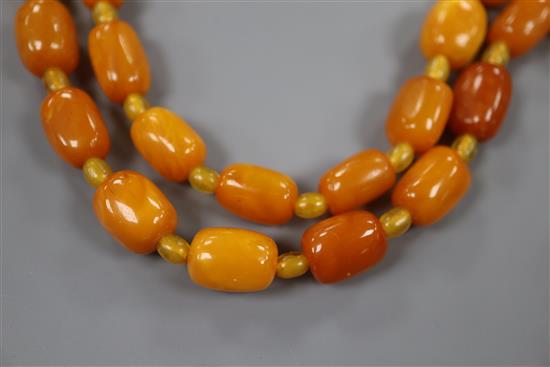 A single strand barrel shaped amber bead necklace, 124cm, gross weight 75 grams.